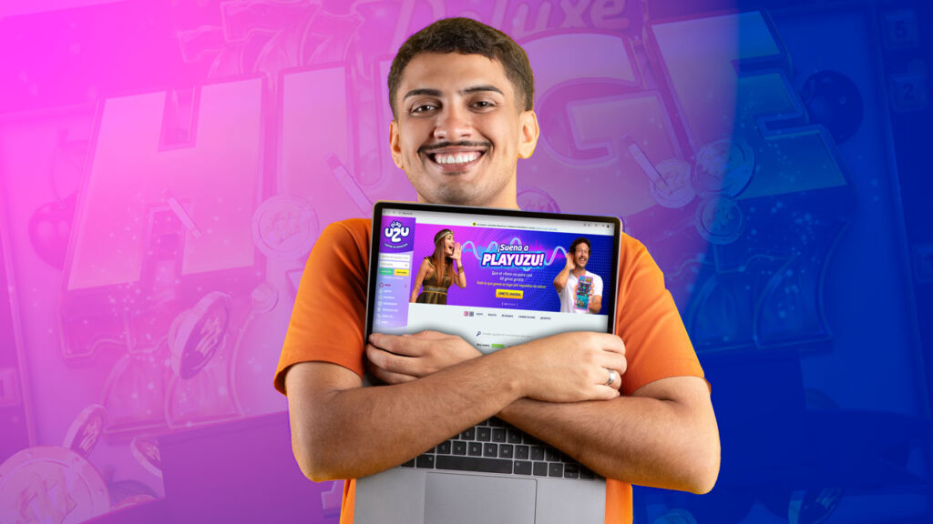 Hombre abrazando su ordenador portátil con una sonrisa, disfrutando la experiencia de los juegos de tragamonedas con jackpots fijos.